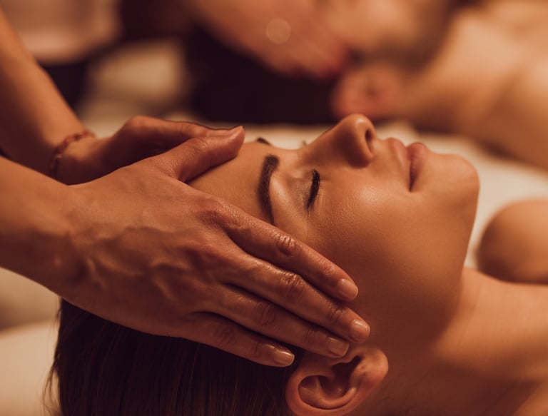 Massage therapist gently massaging a client’s neck and shoulders
